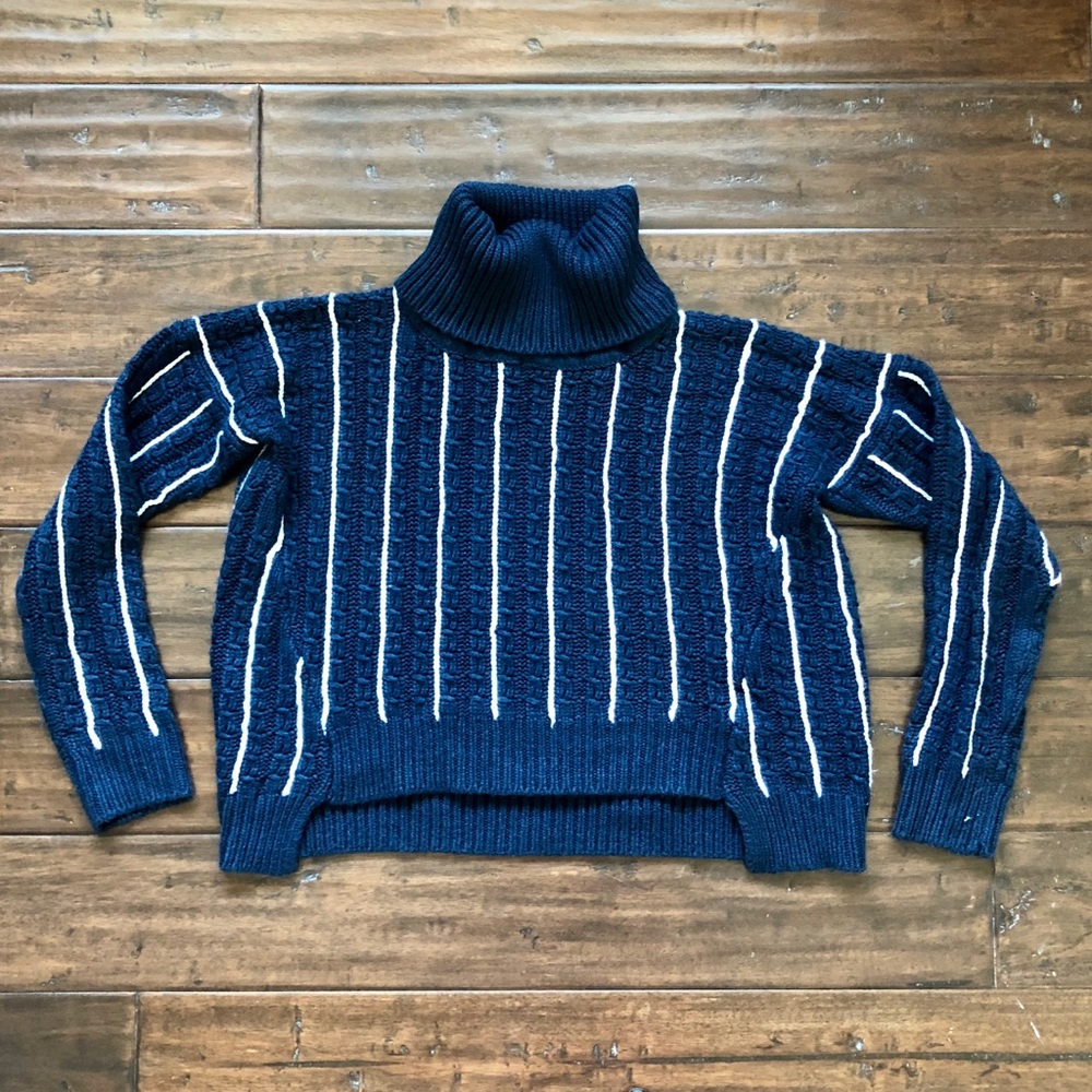 Blue and white vertically stripped turtle neck.